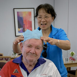 Aged care person with a man in a wheelchair
